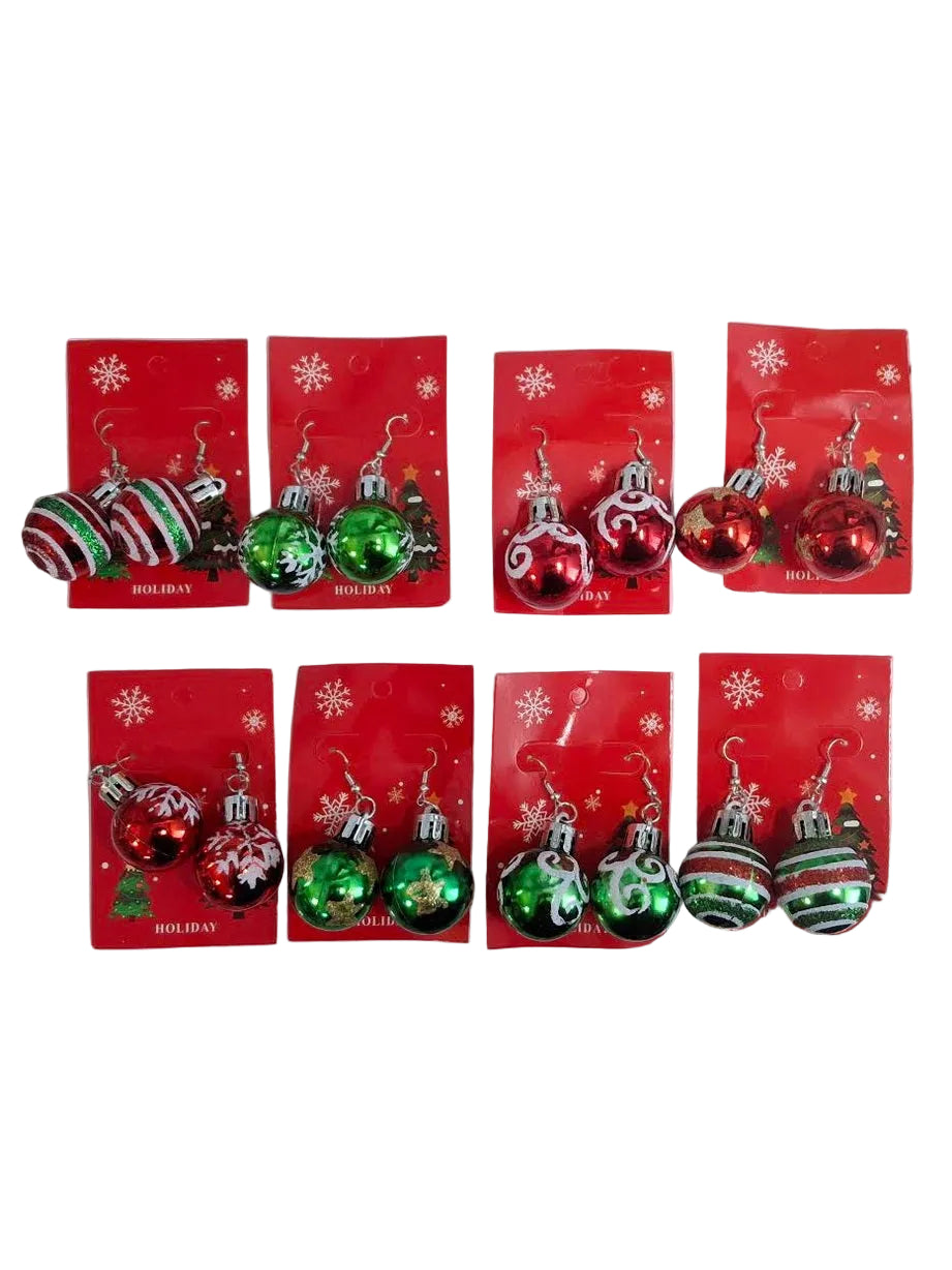 Six pairs of Christmas ornament sets on red backing cards, arranged on a white sheet over a speckled granite countertop. The ornaments include shiny red, green, striped red-and-white, and striped green-and-white styles.