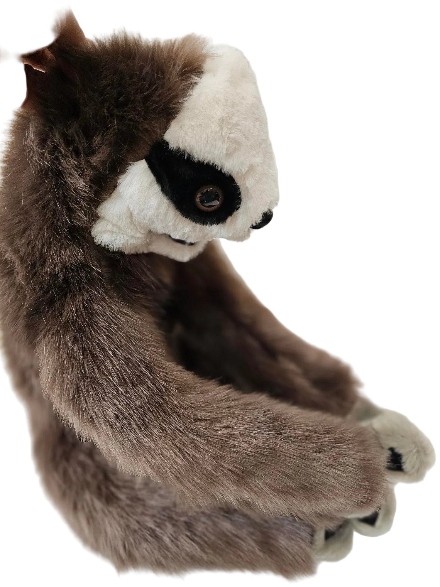A plush sloth toy with brown and white fur, held by a hand against a white background.
