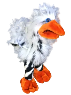 A plush bird toy with fluffy white feathers, a bright orange beak and feet, and black-and-white striped legs, photographed against a dark grid background.