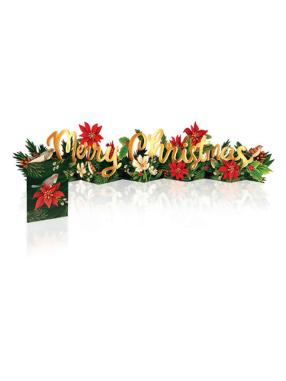 A festive Christmas pop-up card or decorative sign with the words “Merry Christmas” in gold script, surrounded by red poinsettias, green foliage, small birds, and white berries on a white background with a reflection below.