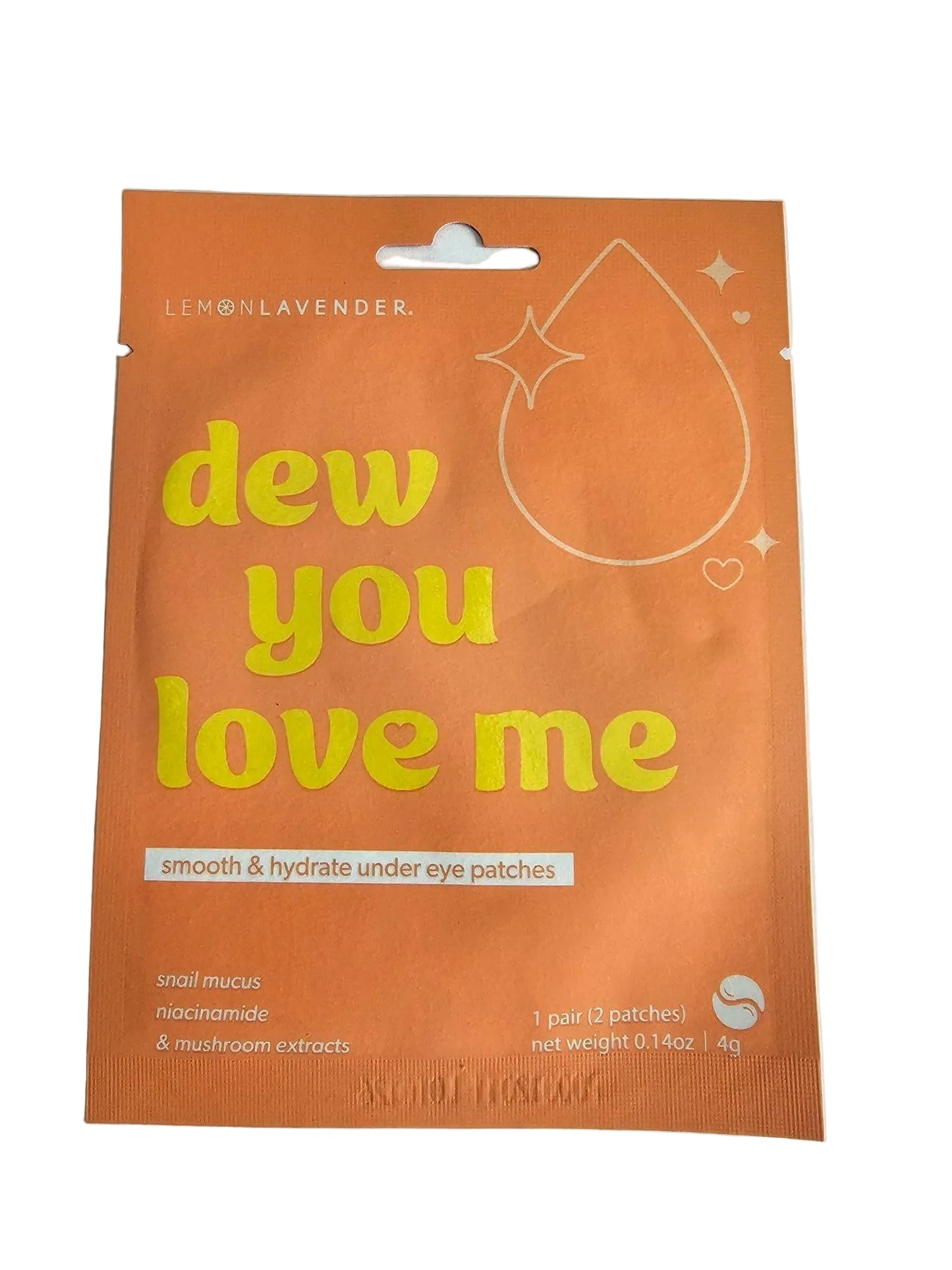 An orange single-use eye patch packet with yellow text reading 'dew you love me' and white text reading 'smooth & hydrate under eye patches', photographed on a light gray surface.