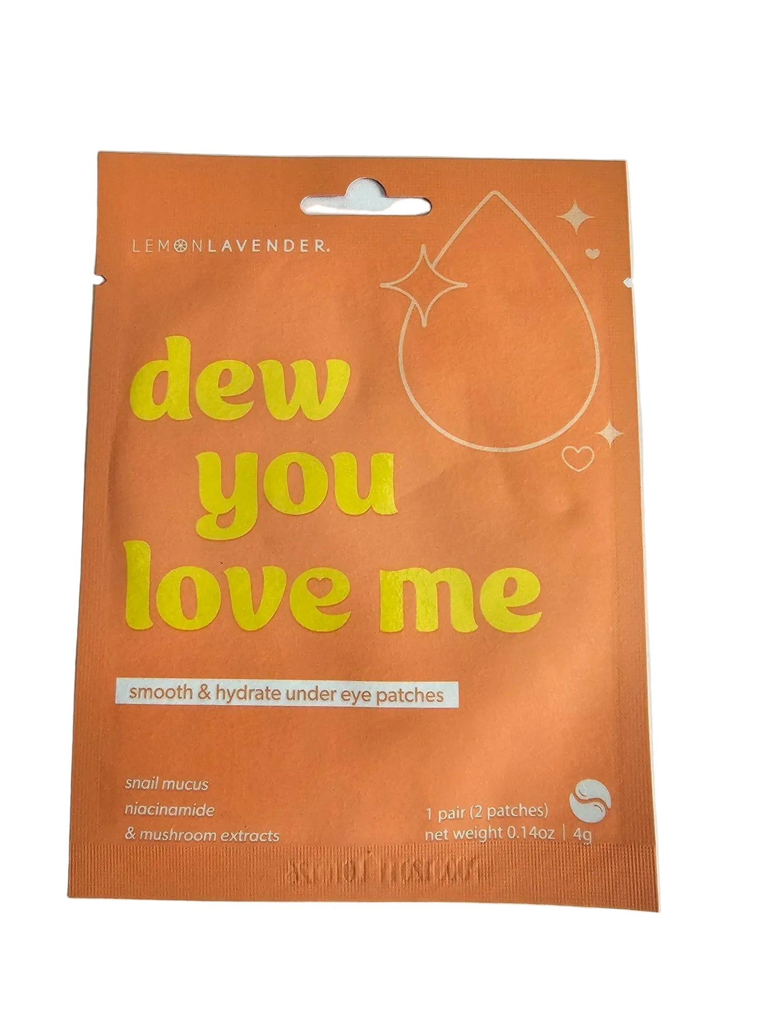 An orange single-use eye patch packet with yellow text reading 'dew you love me' and white text reading 'smooth & hydrate under eye patches', photographed on a light gray surface.